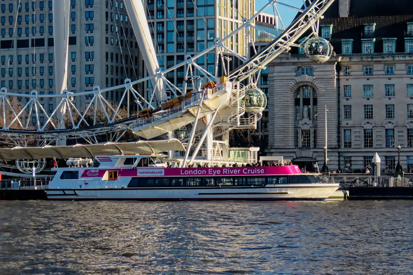 Sightseeing boat moored at London Eye Pier below the London Eye