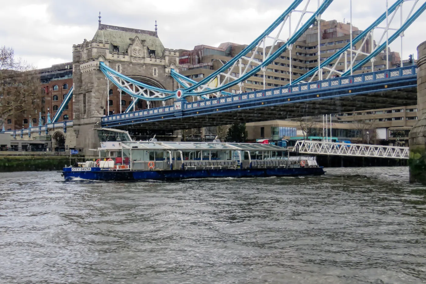 Thames sightseeing boat passing near Tower Bridge